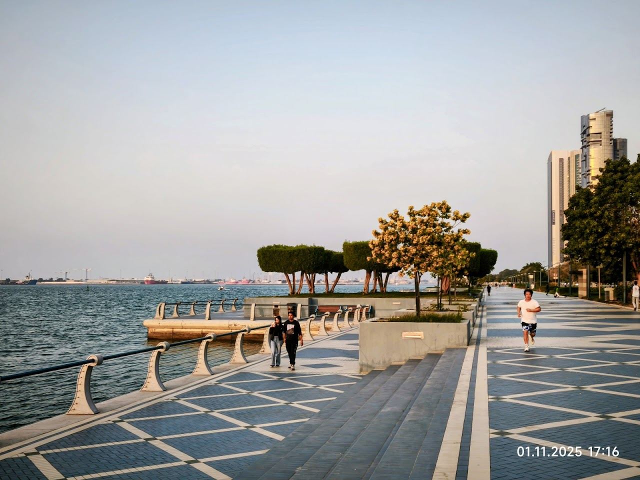 Golden evening light over the Gulf and the city skyline along the Corniche in Abu Dhabi