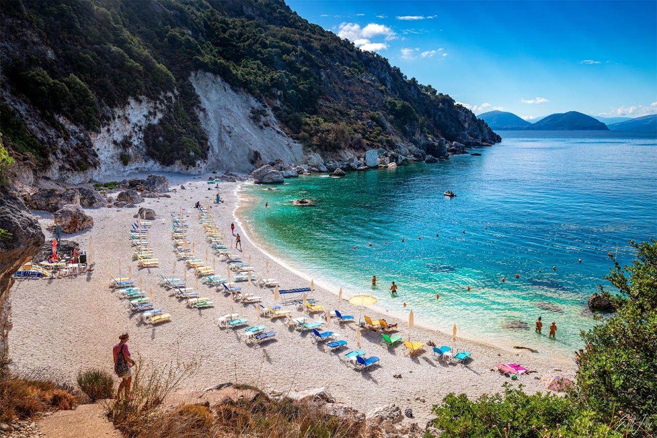 The bright turquoise shallows and white pebbles of the small Agiofili cove near Vasiliki in Lefkada