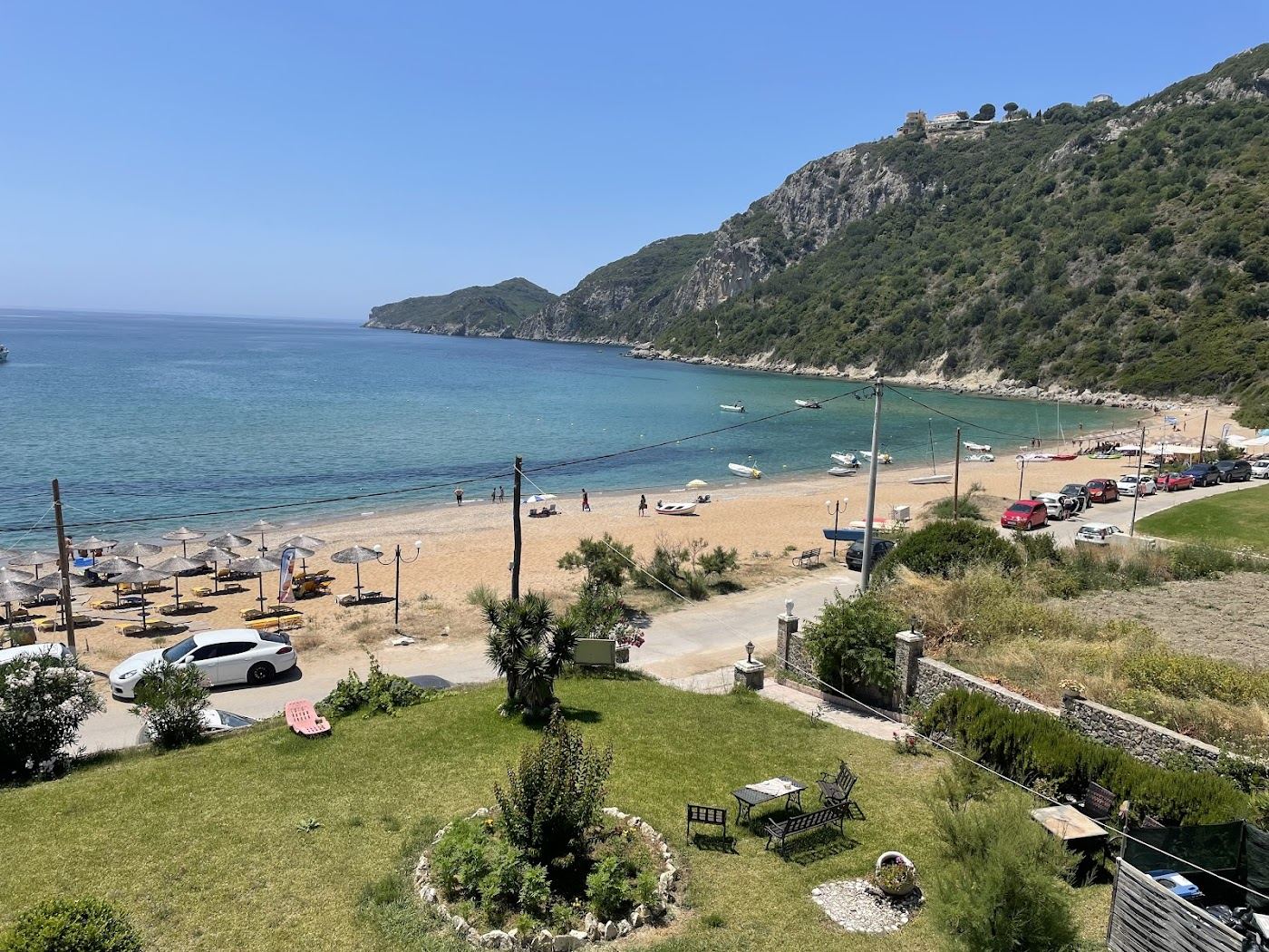 Calm clear water along the sandy bay at Agios Georgios Pagon, Corfu