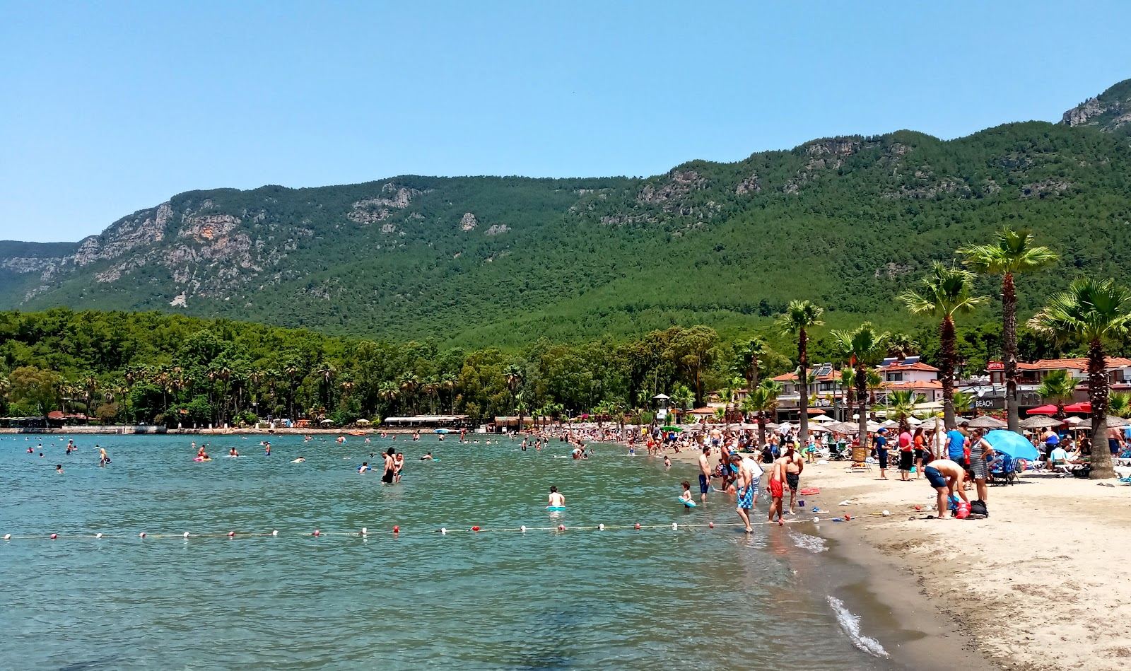Akyaka beach and the Gulf of Gokova with shallow turquoise water and pine hills near Marmaris in Turkey