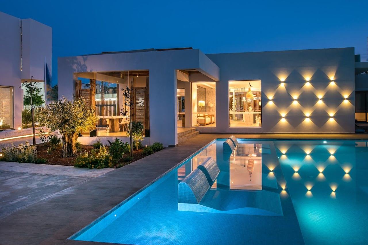 A calm clear bay below a stylish small resort on the coast of Crete