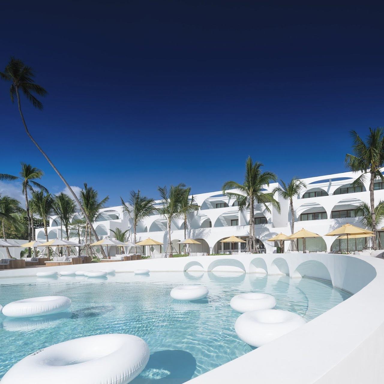 A palm backed beach below a stylish resort on the calmer north of Koh Samui
