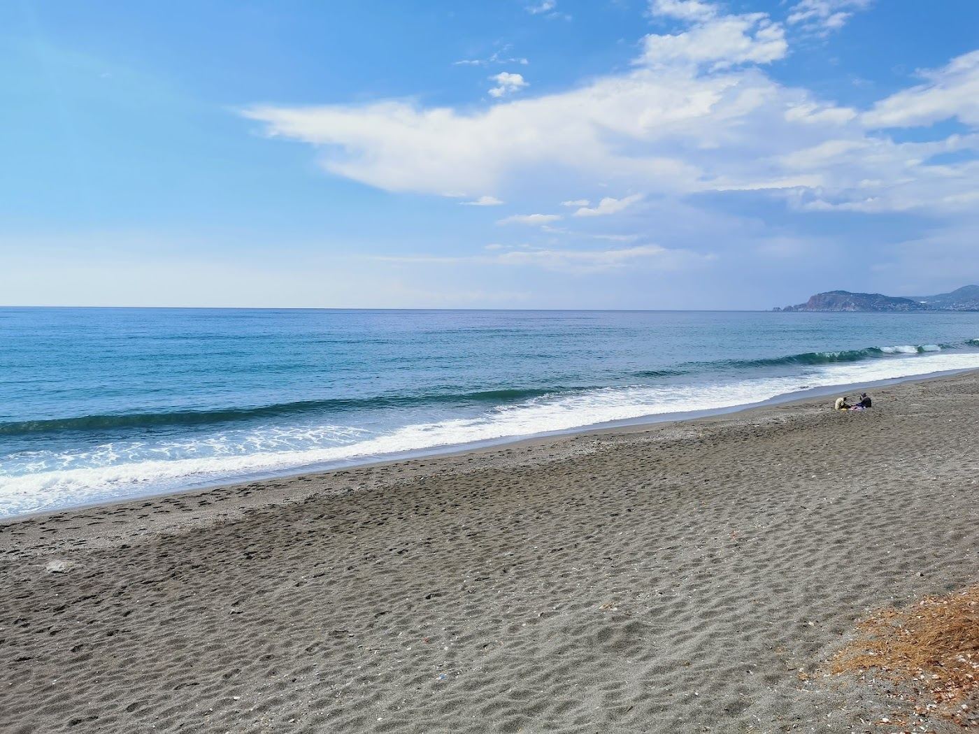 Long pebble shore and clear water backed by the Taurus mountains at Mahmutlar Beach east of Alanya