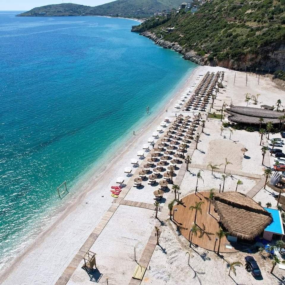 The long quiet beach of Borsh backed by olive groves on the Albanian Riviera
