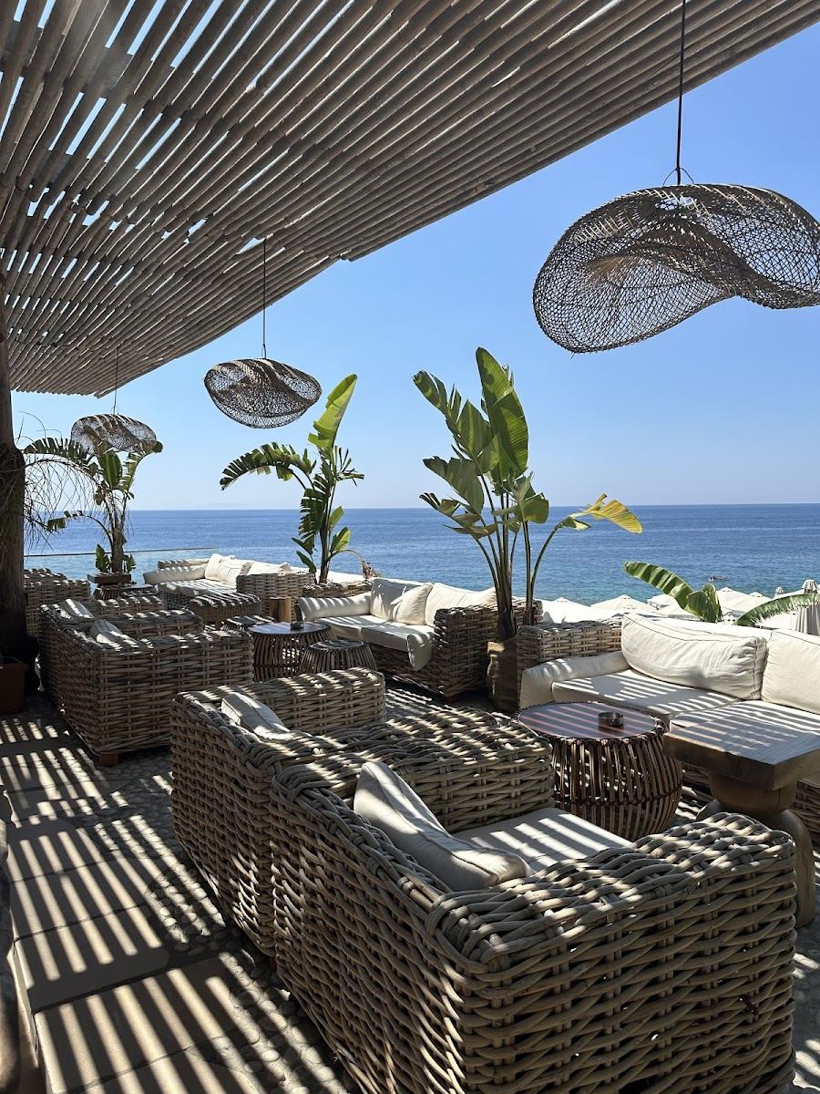 Bali inspired daybeds and clear sea at Sanur Beach House in Dhermi on the Albanian Riviera