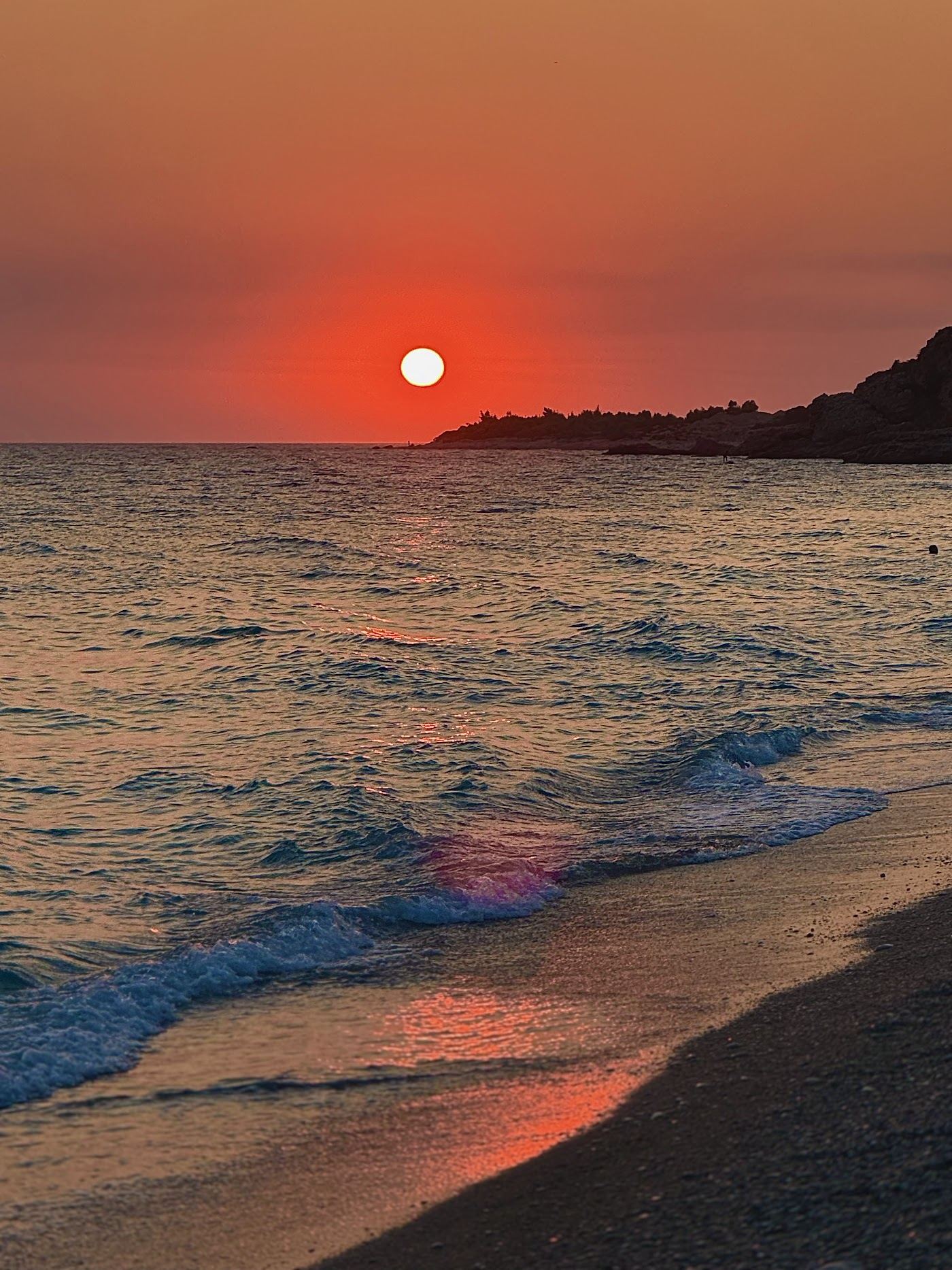 Paddlers and clear water at Palase, a watersports beach on the Albanian Riviera