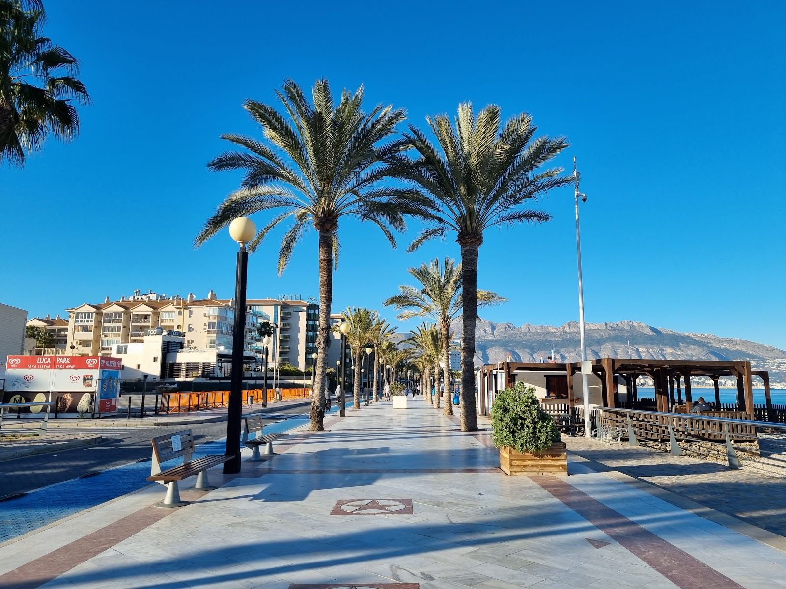 Playa del Albir, the white pebble beach and palm lined promenade in L'Alfas del Pi