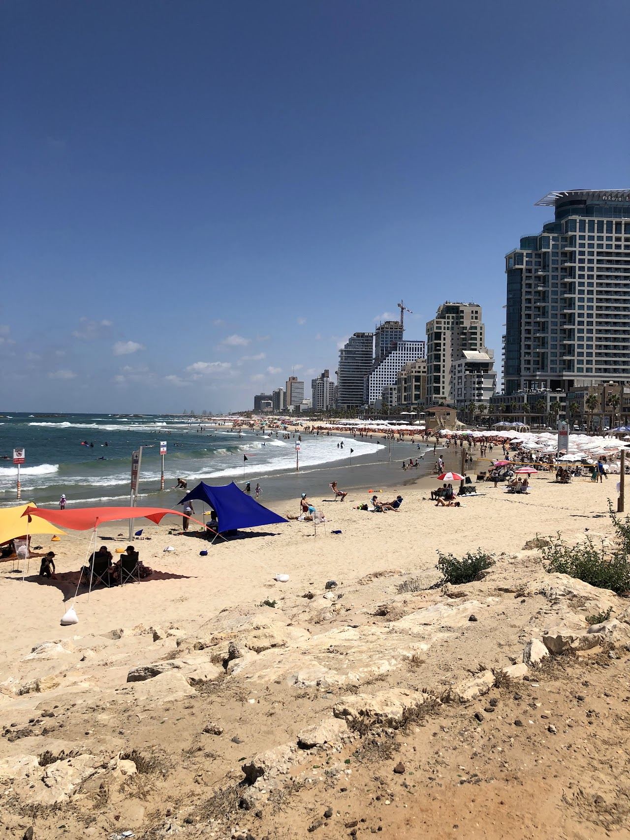 The open sand of Alma beach in southern Tel Aviv with the Jaffa skyline at dusk