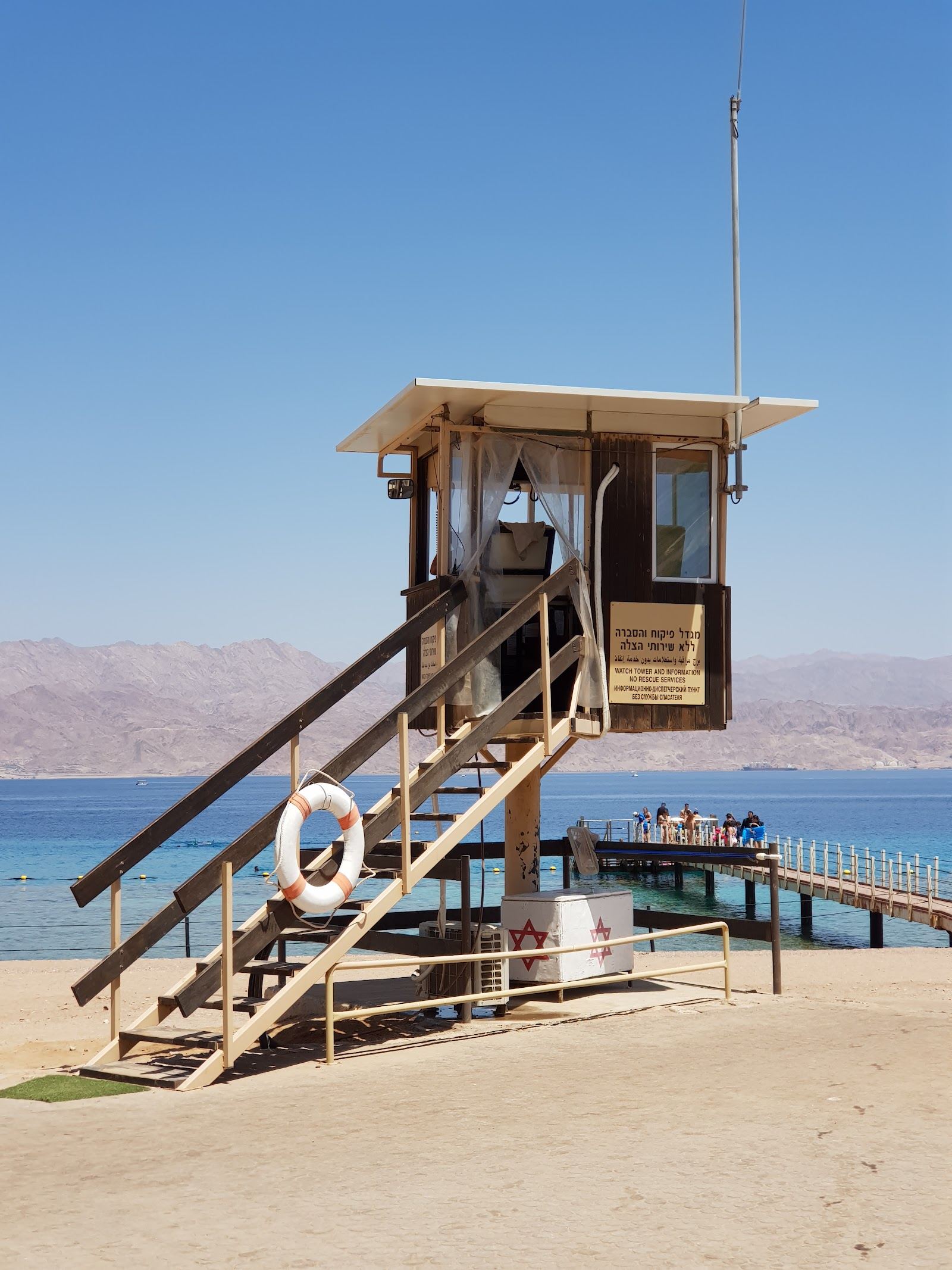 The clear Red Sea water and desert mountains at Almog Beach in Eilat