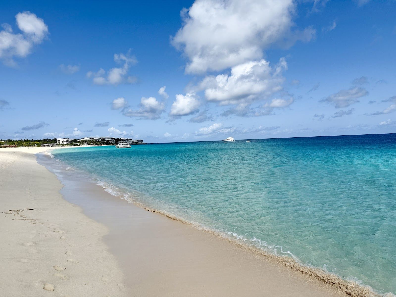 Flat clear turquoise water over white sand on a sheltered Anguilla bay