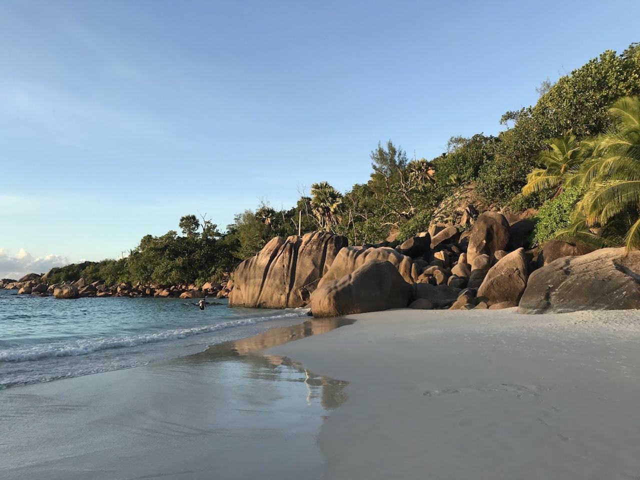 Wide curve of white sand, granite headlands and clear blue water at Anse Lazio on Praslin in Seychelles