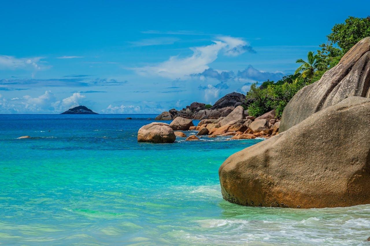 Clear water and granite boulders at the northern end of Anse Lazio bay on Praslin