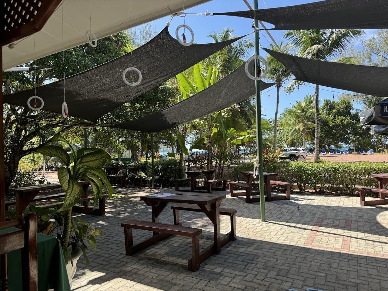 Seating and beach view at Le Chevalier restaurant on Anse Lazio, Praslin