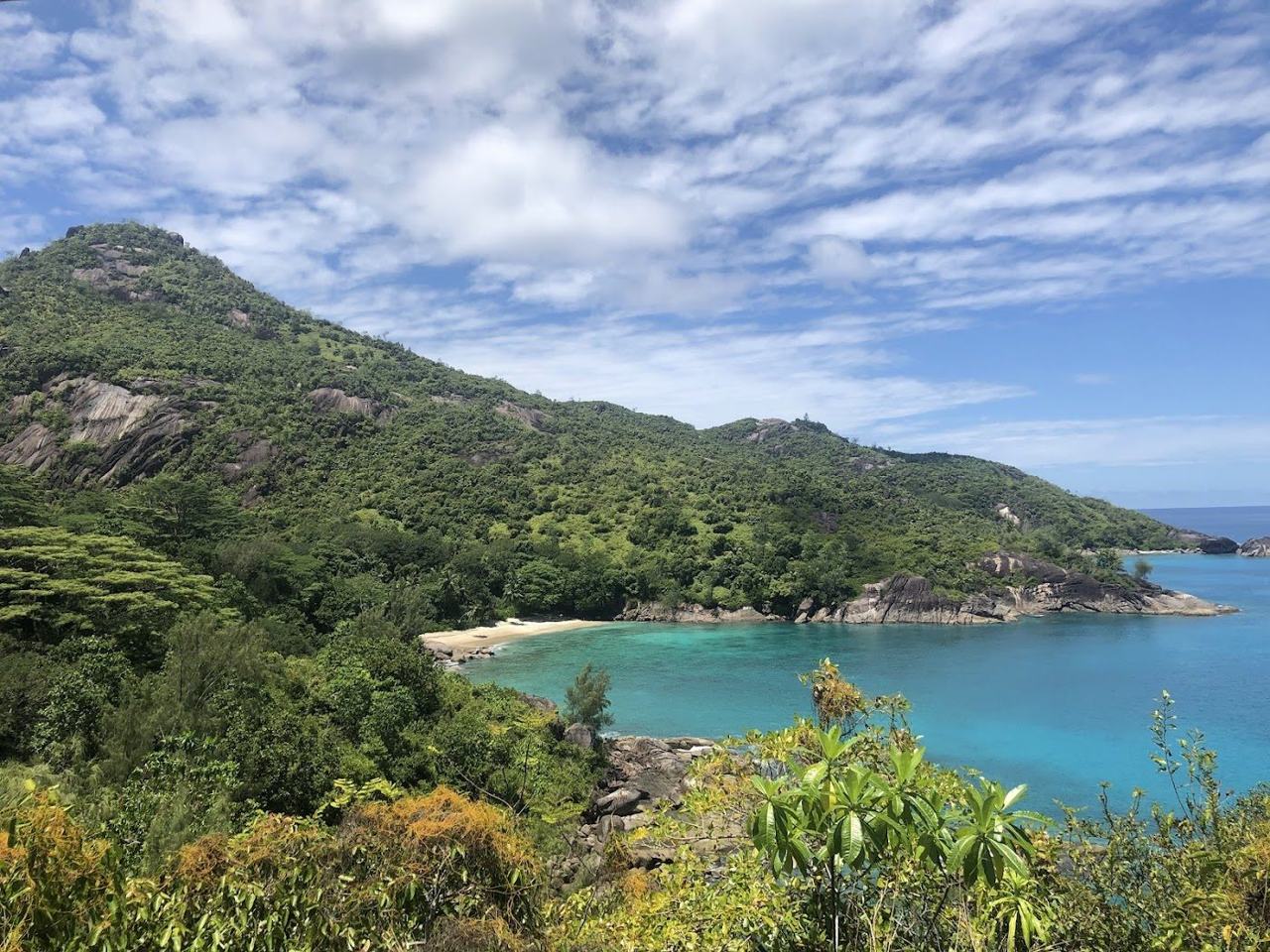 Small wild beach backed by granite cliffs at Anse Major on the north west coast of Mahe in Seychelles