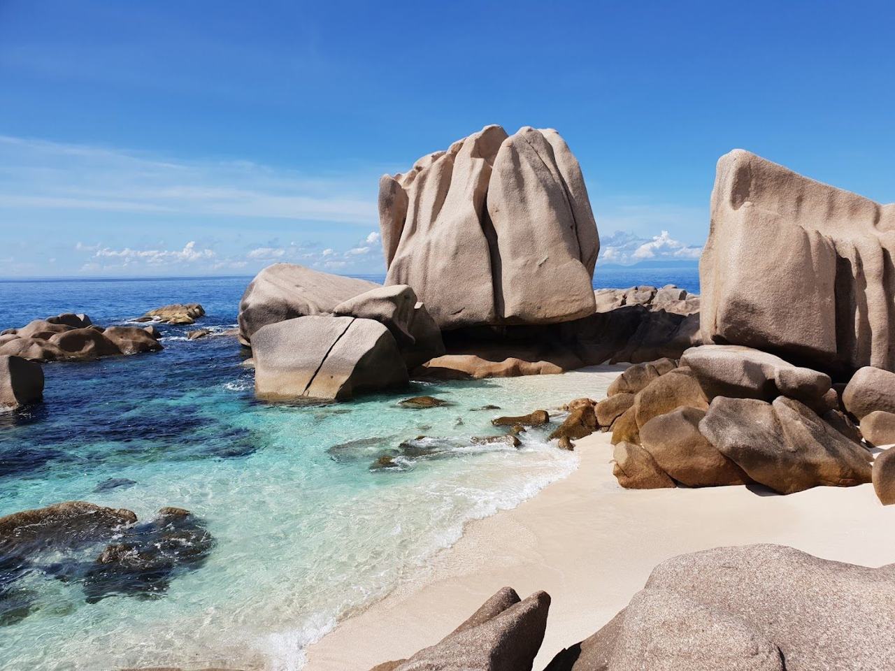 Giant granite boulders framing a sheltered natural pool at Anse Marron on the south coast of La Digue in Seychelles