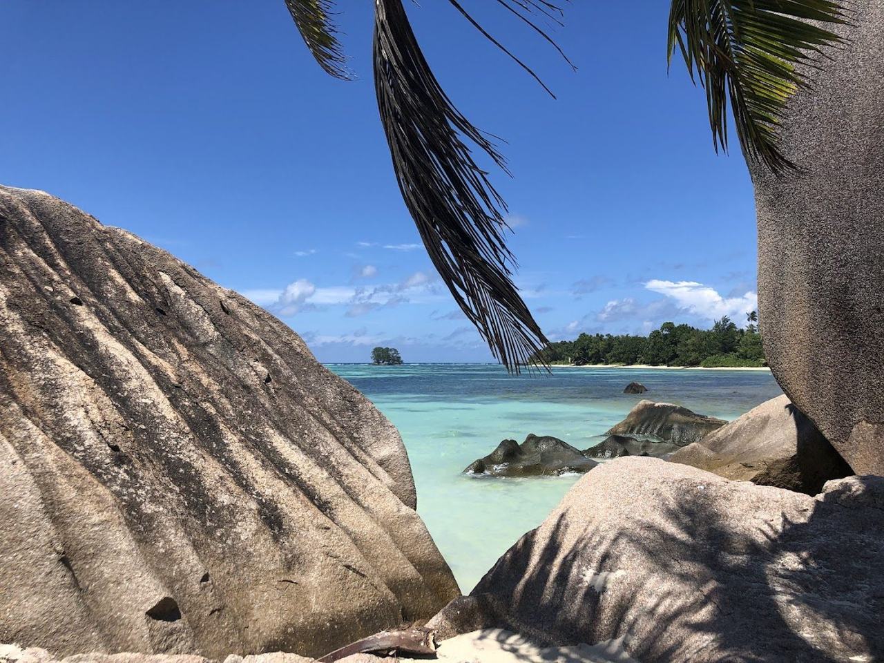Smooth granite formations framing the shallow lagoon at Anse Source d'Argent on La Digue