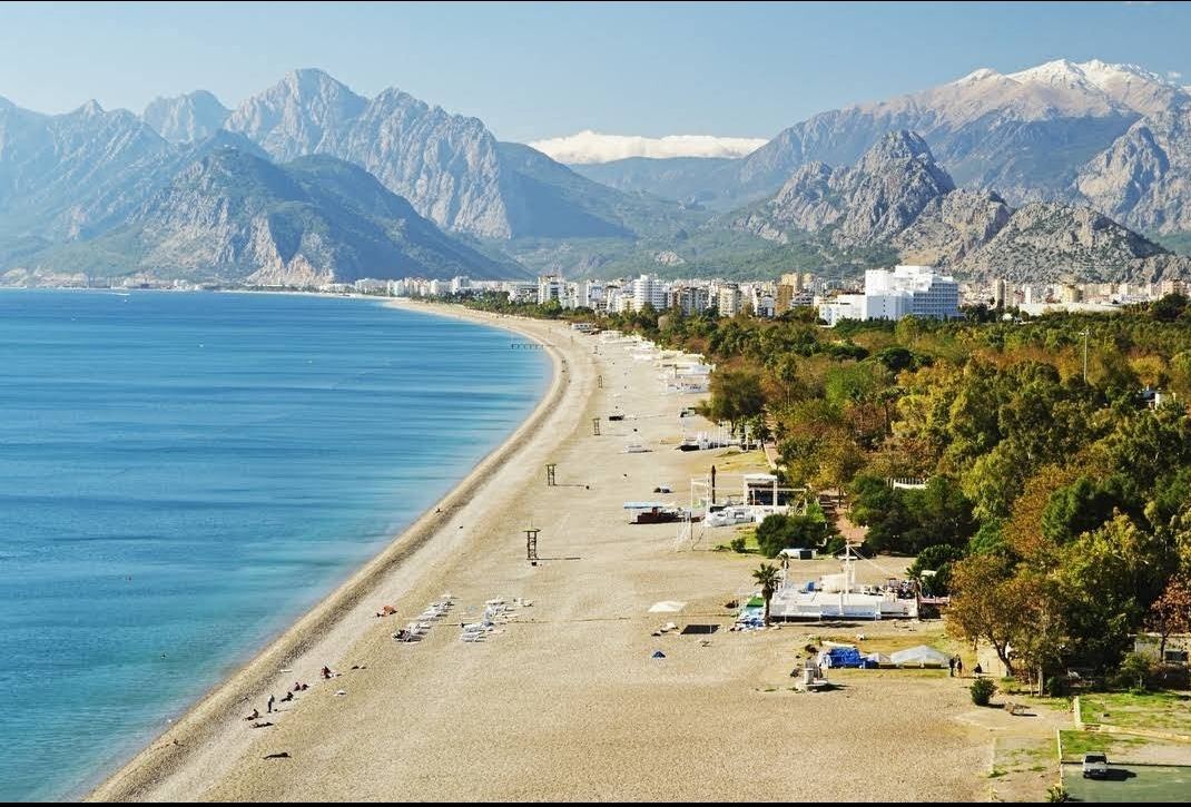 The long free public sweep of Konyaalti Beach under the Taurus mountains in Antalya