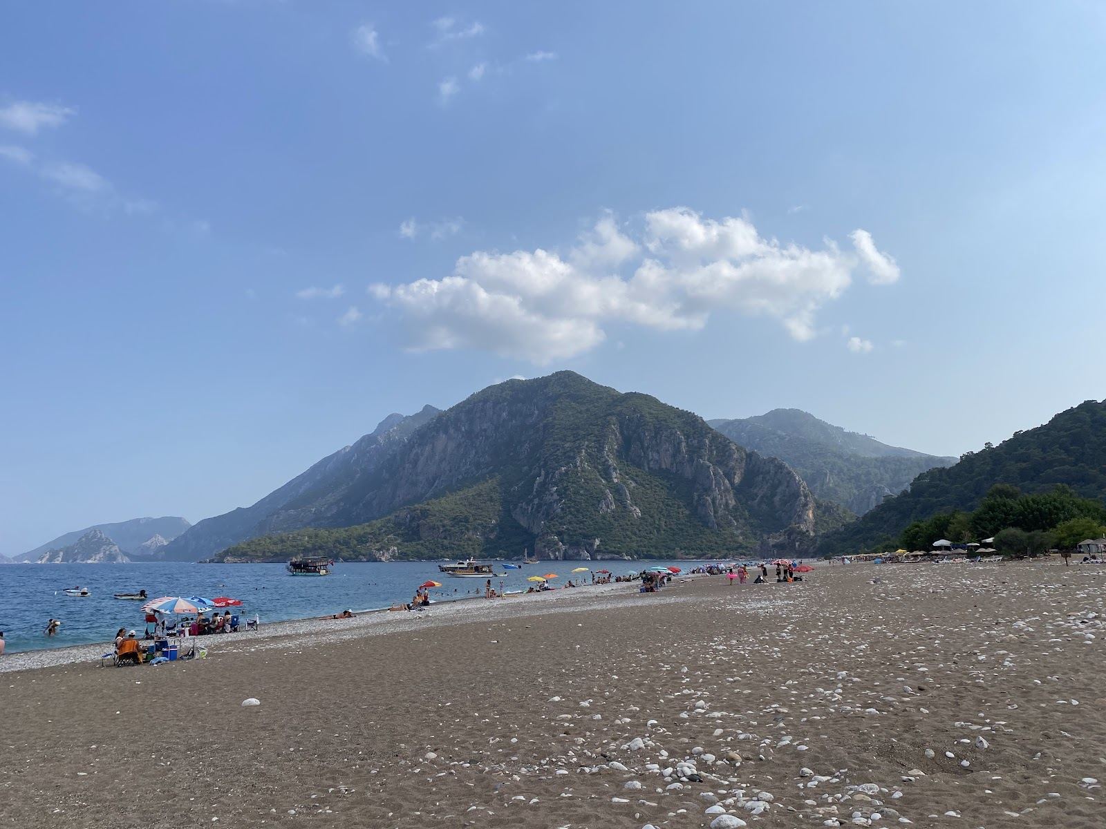 The quiet long shore at Cirali below pine clad hills near Olympos on the Antalya coast at golden hour