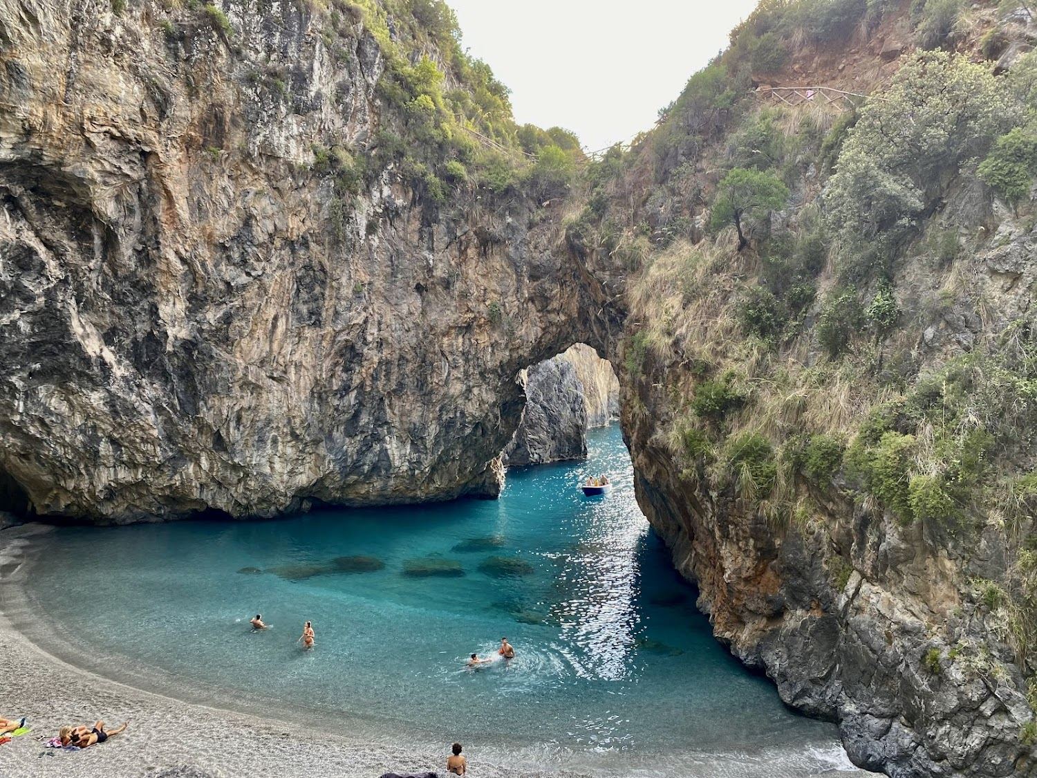 A hidden crescent cove and a great natural rock arch at Arcomagno near San Nicola Arcella in Calabria