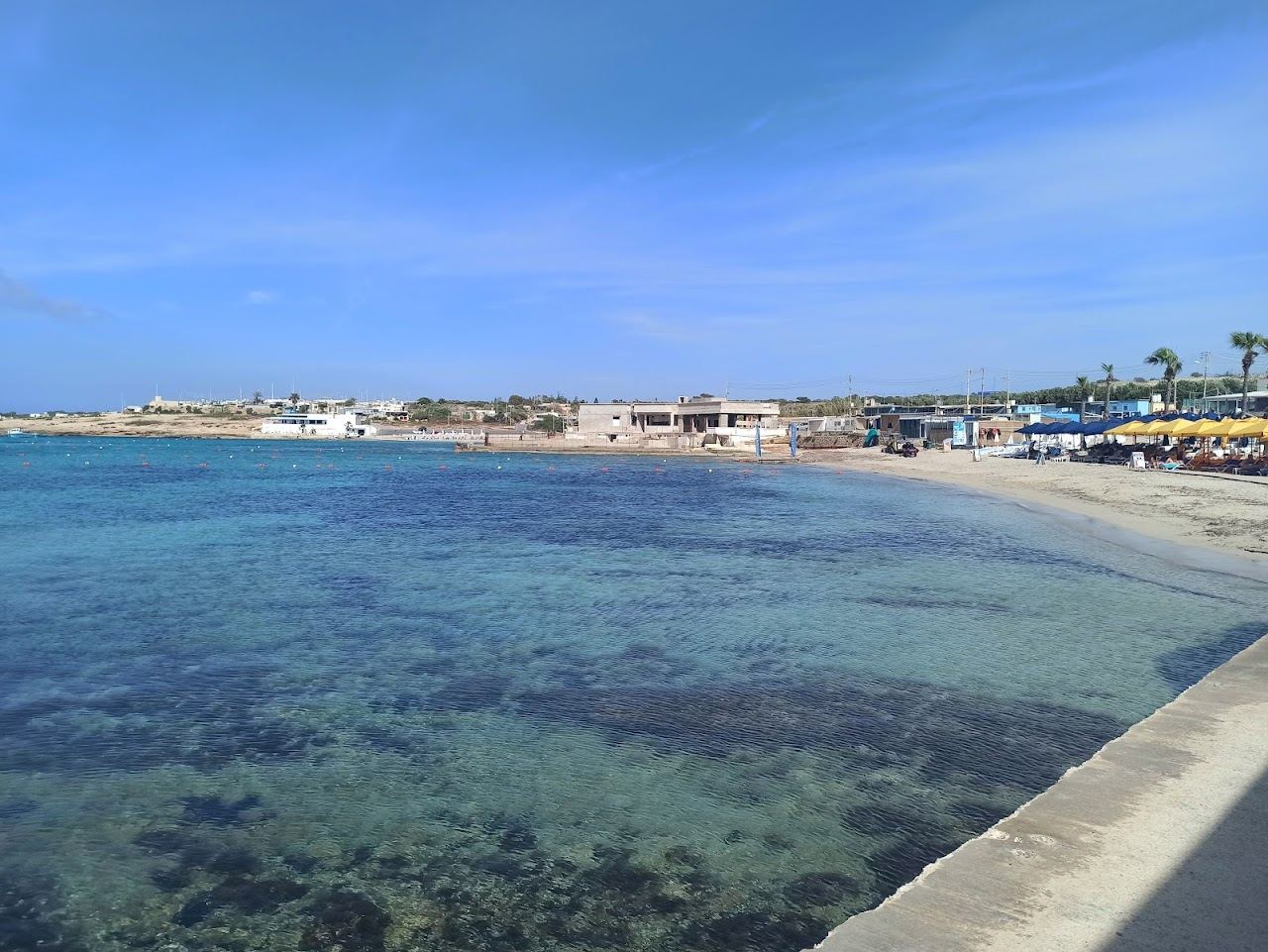 The shallow sandy water of Armier Bay near Mellieha in northern Malta with Comino on the horizon