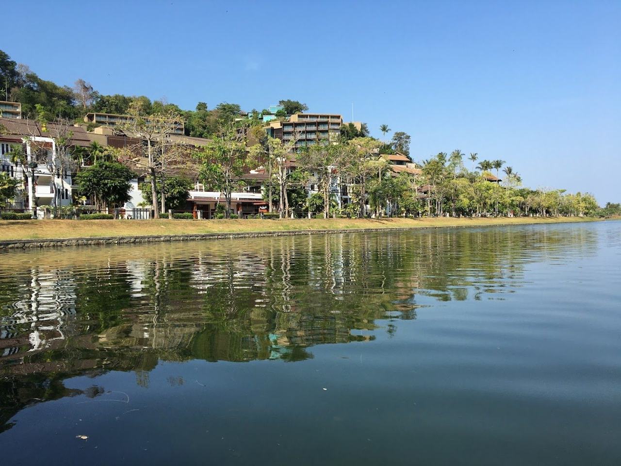 The calm bay and pale sand of Nai Harn beach in southern Phuket