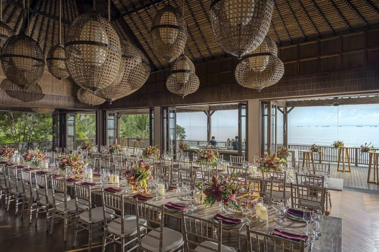 A long infinity pool and beachfront daybeds on the calm sand of Jimbaran Bay, attached to the Four Seasons.
