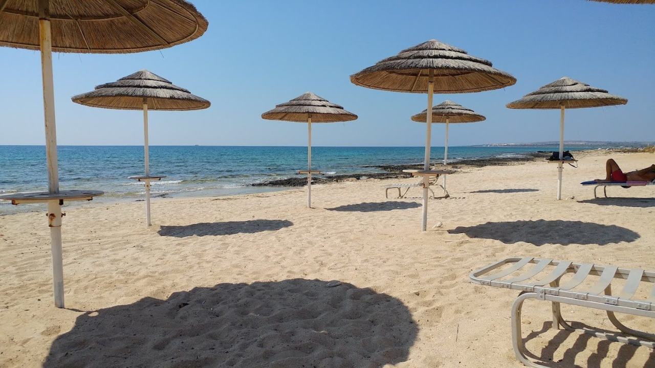 Shallow sheltered water and a small islet off the golden sand at Ayia Thekla on the southeast coast of Cyprus