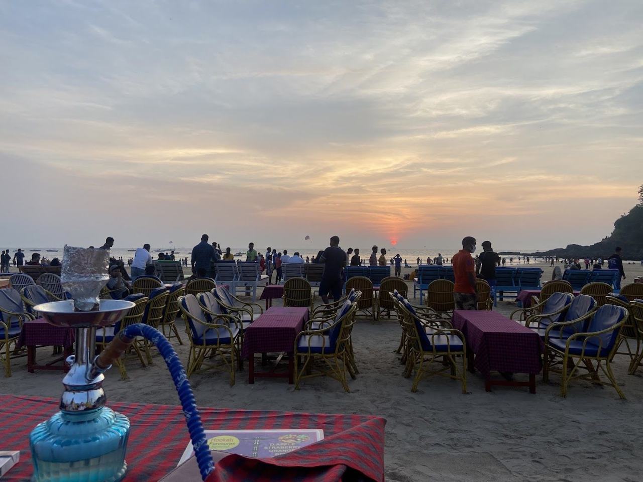 Baga Beach busy golden sand with water sports boats and shacks in North Goa