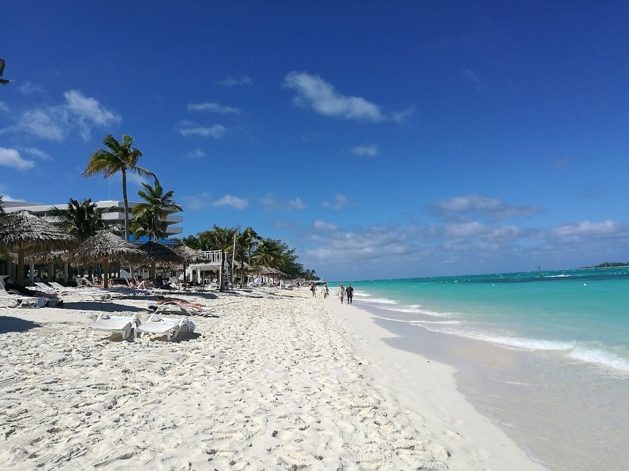 Calm turquoise water and pale sand in warm evening light at Cable Beach near Nassau in the Bahamas
