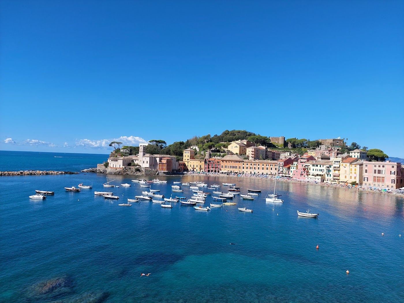 The sheltered sandy Bay of Silence ringed by colourful houses at Sestri Levante in Liguria