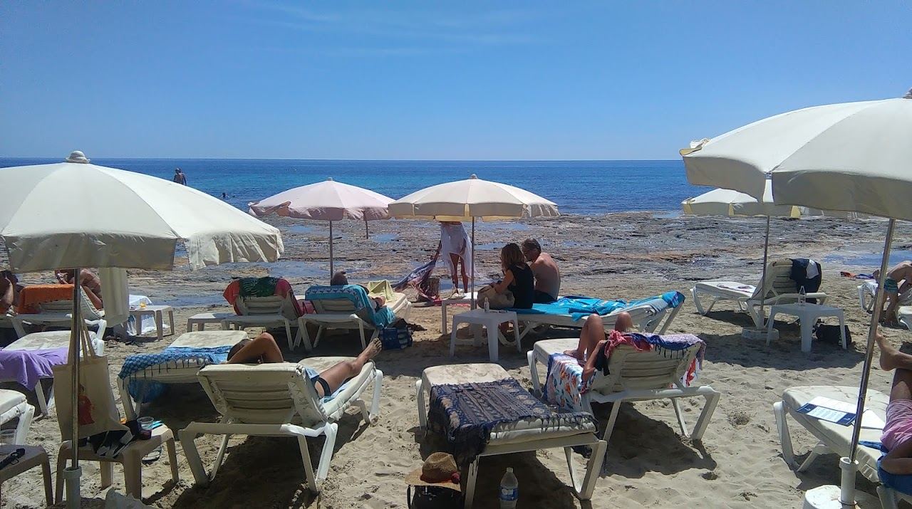 Natural sand, juniper and clear water at Ses Salines beach on Ibiza