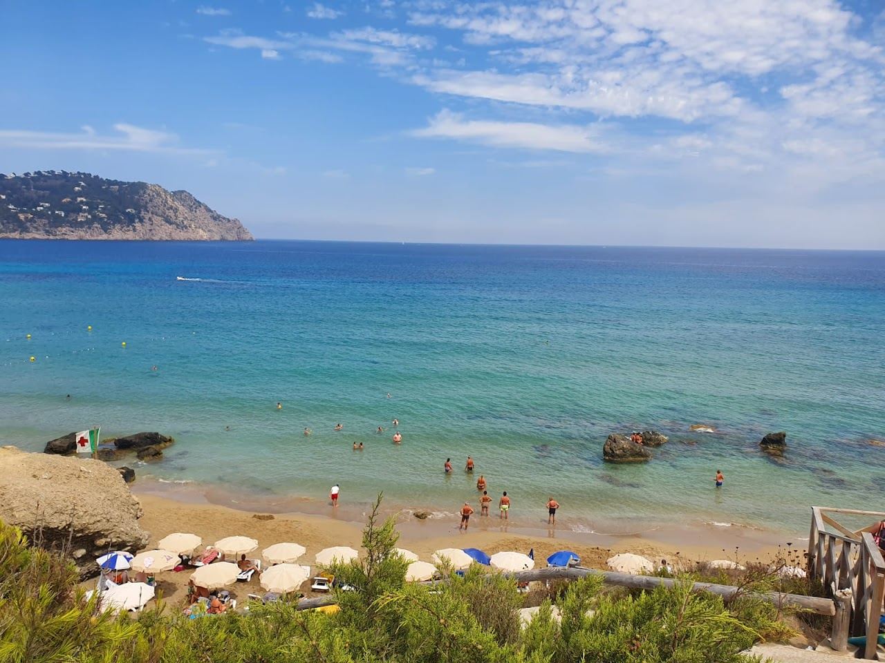 The cliff backed strip and steps down to Aguas Blancas beach on Ibiza