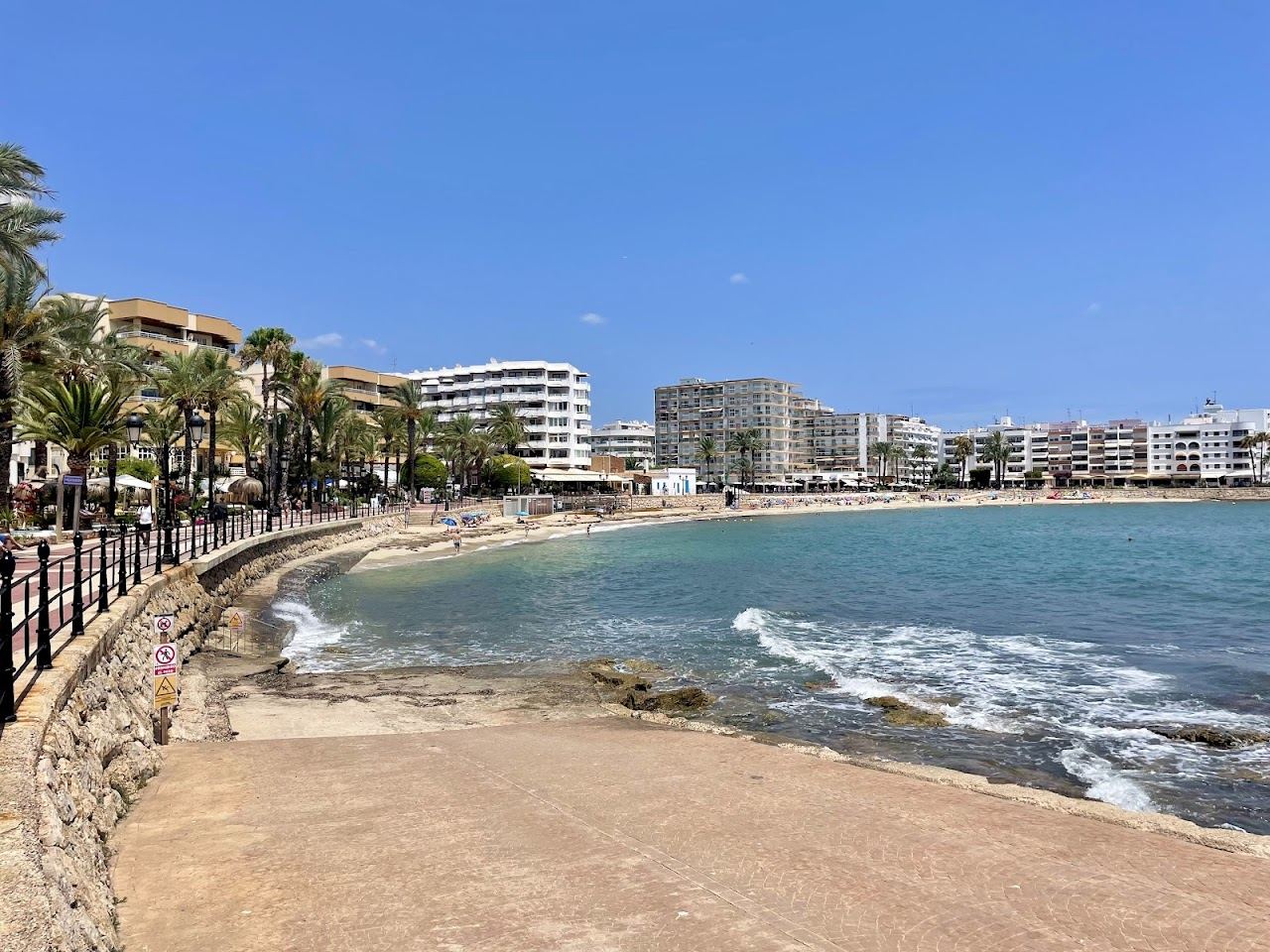 The palm promenade and calm town beach at Santa Eulalia on Ibiza