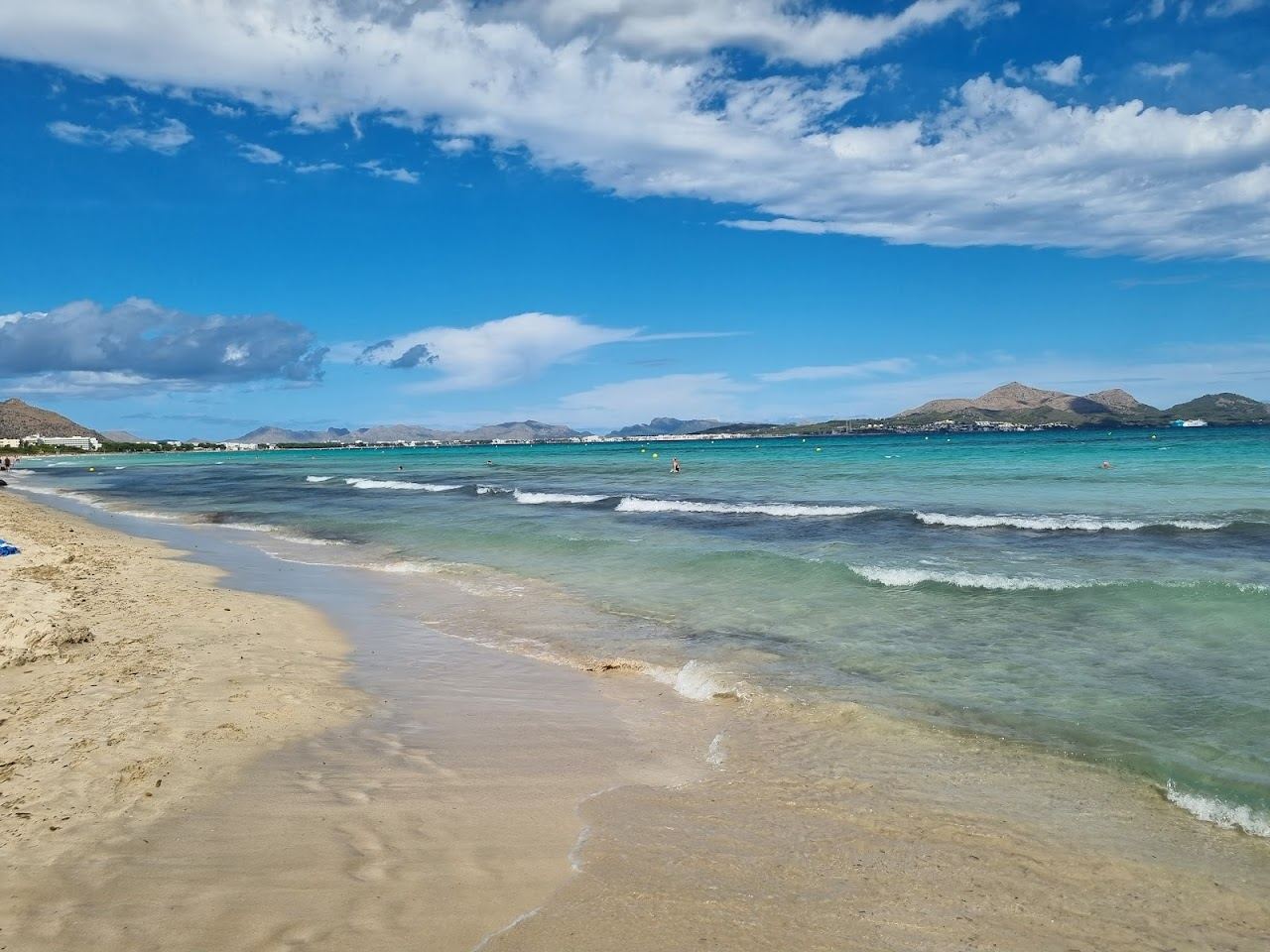 The long pale sand and shallow water of Playa de Muro in the Alcudia bay on Mallorca