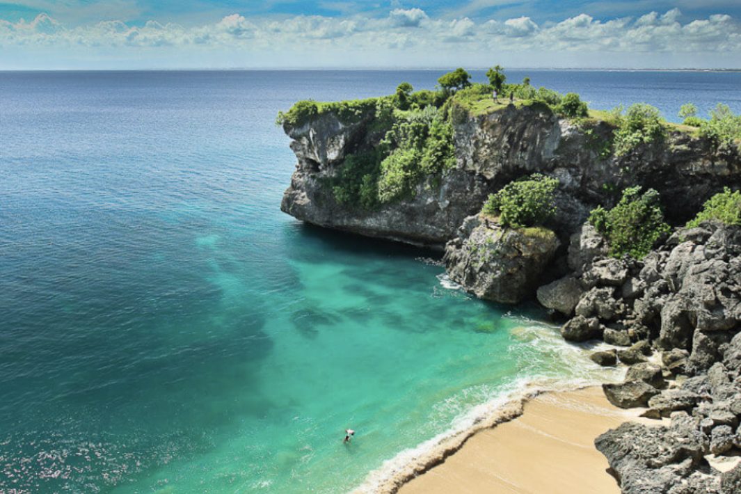White sand below cliffs and a left reef break at Balangan Beach on the Bukit in Bali