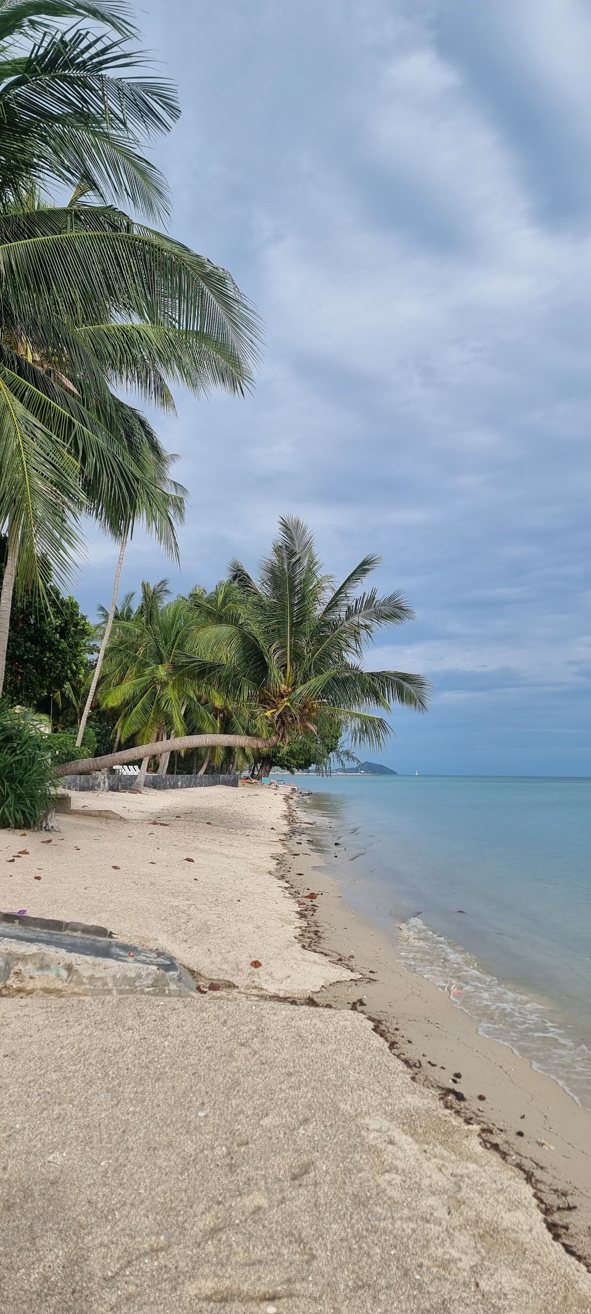 The shallow reef sheltered water and long shoreline of Ban Tai on the south coast of Koh Phangan
