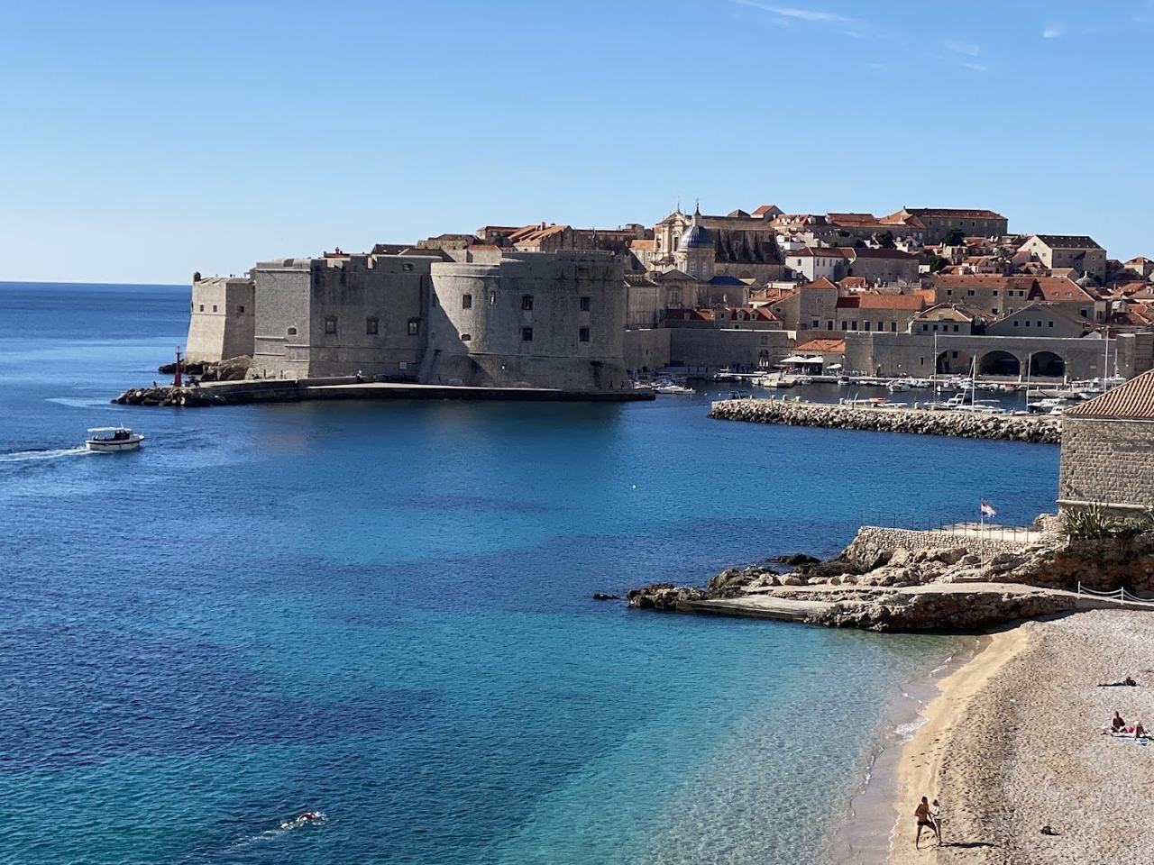 Banje Beach pebble shore below the old town walls of Dubrovnik on the Dalmatian Coast