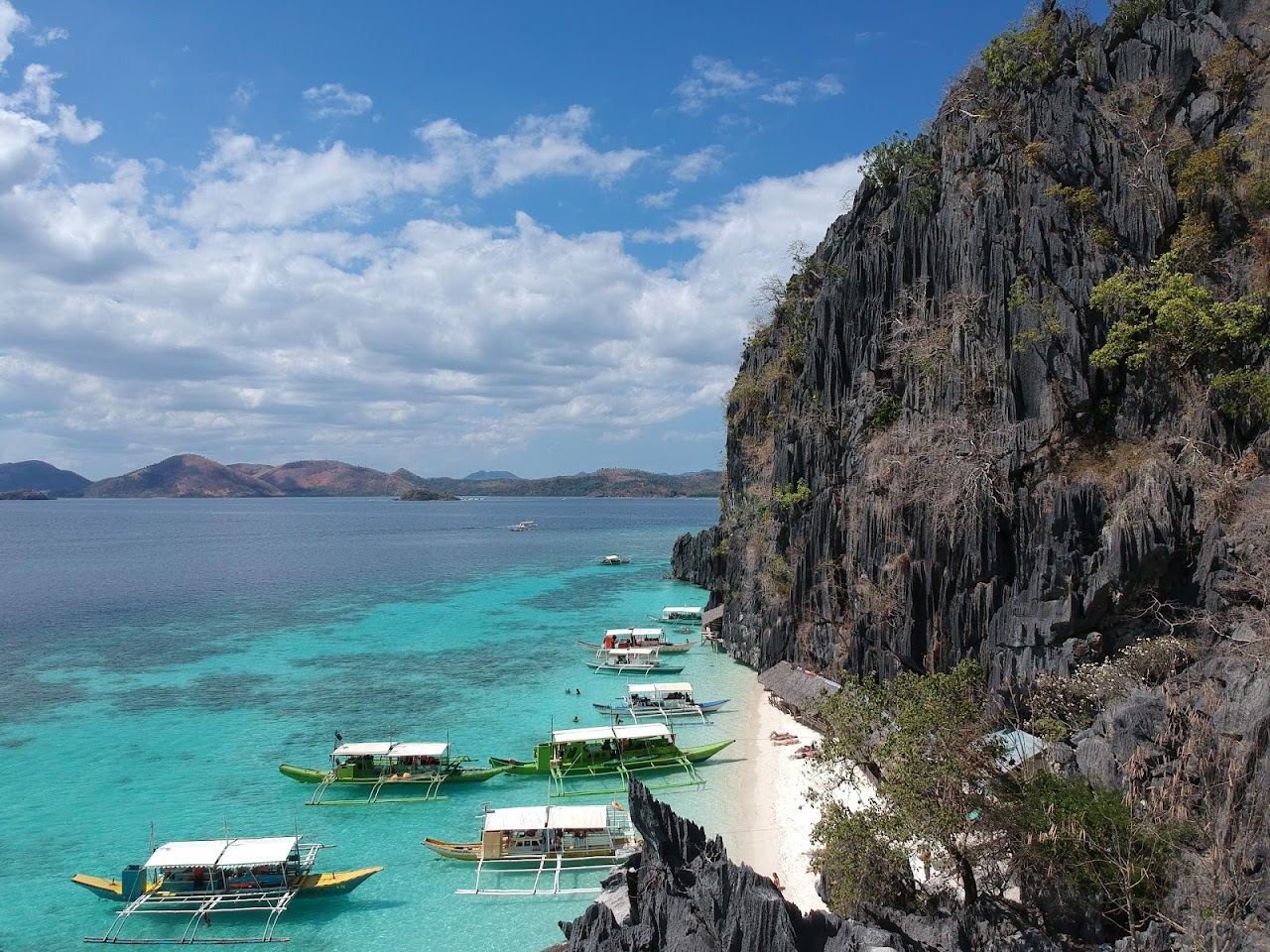 Banol Beach small white sand cove with karst backdrop near Coron Palawan