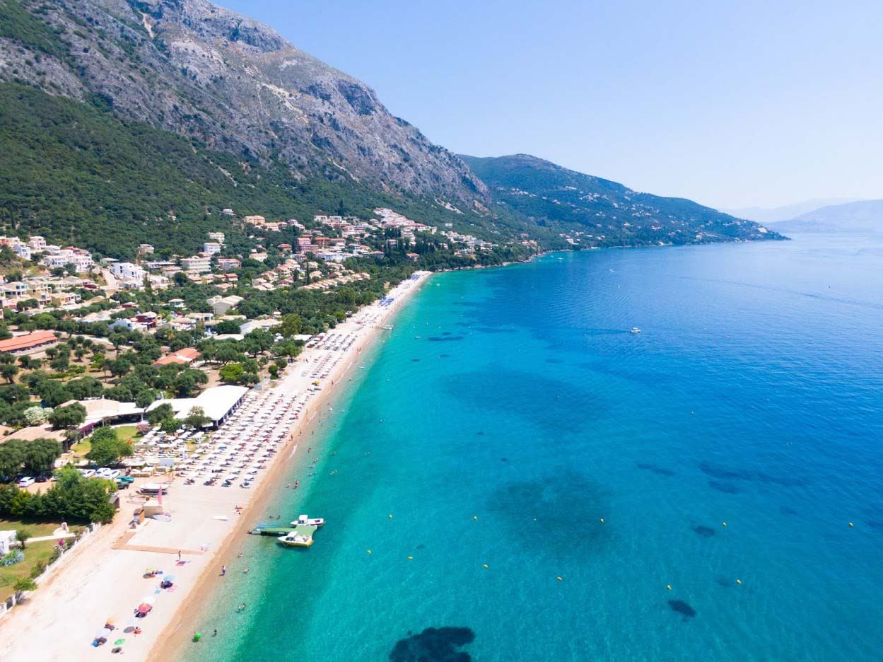 Clear blue water over white pebbles at Barbati beach, Corfu