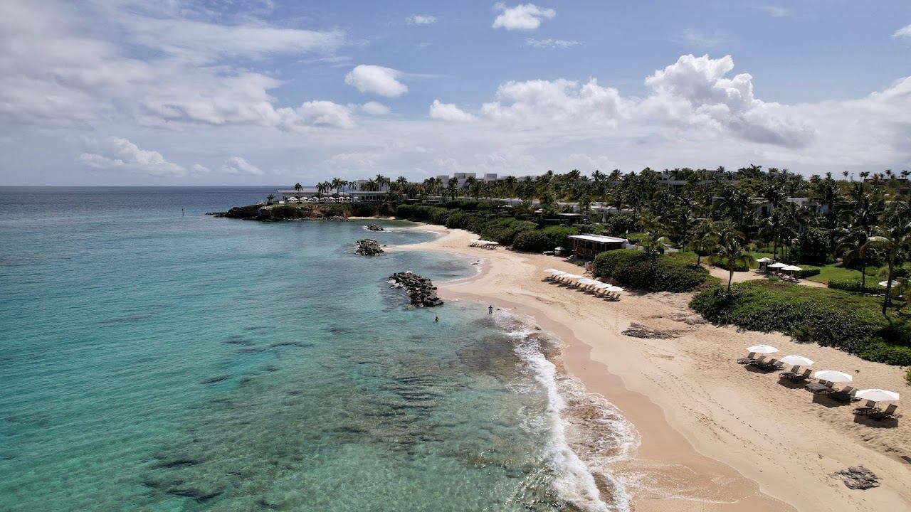 Palm lined calm water at Barnes Bay on the west coast of Anguilla