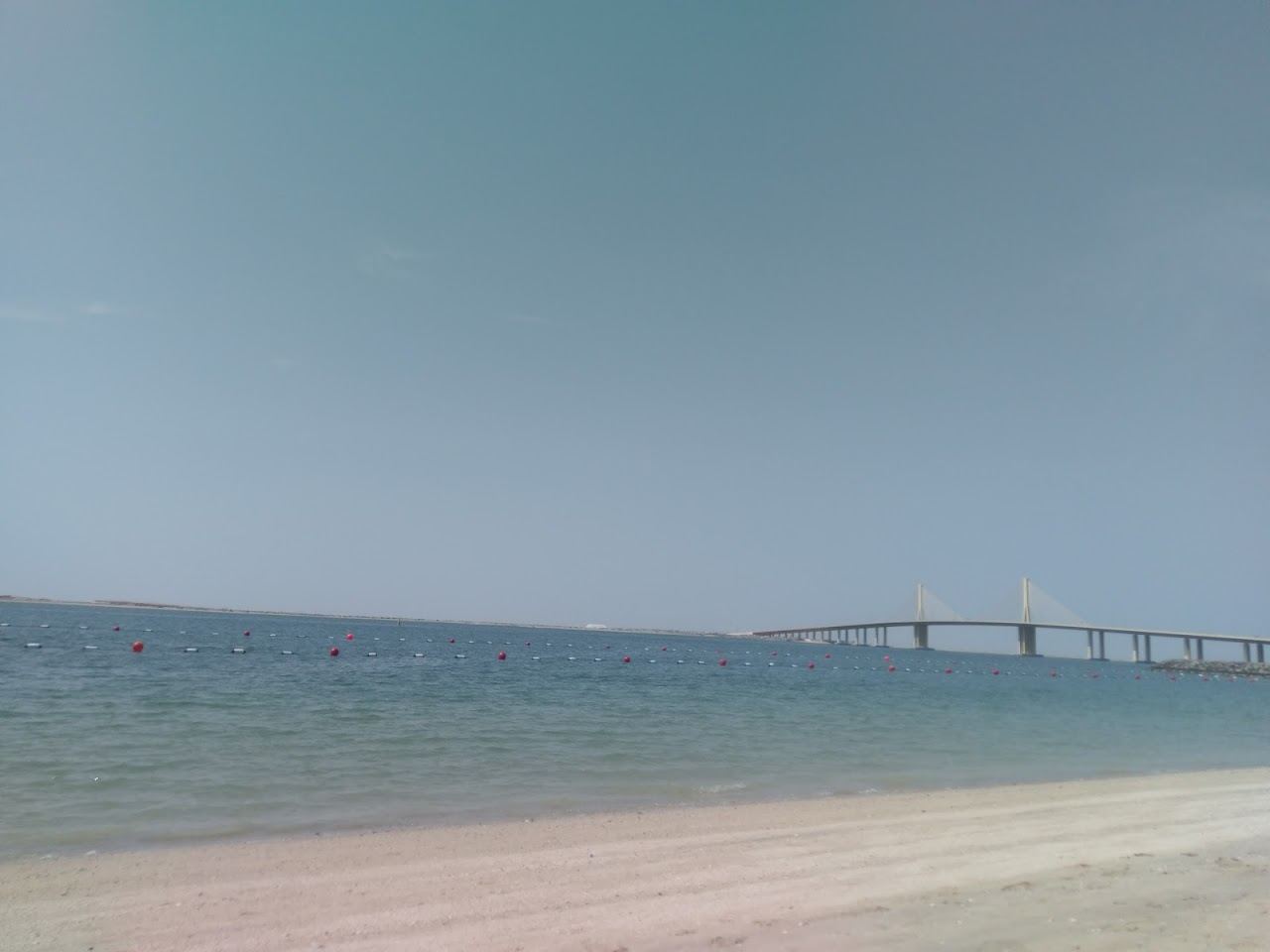 Calm Blue Flag water and groomed sand at Bateen Beach by the Marsa Al Bateen marina, Abu Dhabi