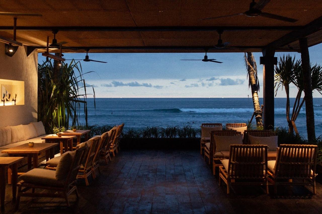 Poolside loungers facing the surf at The Lawn in Batu Bolong Canggu