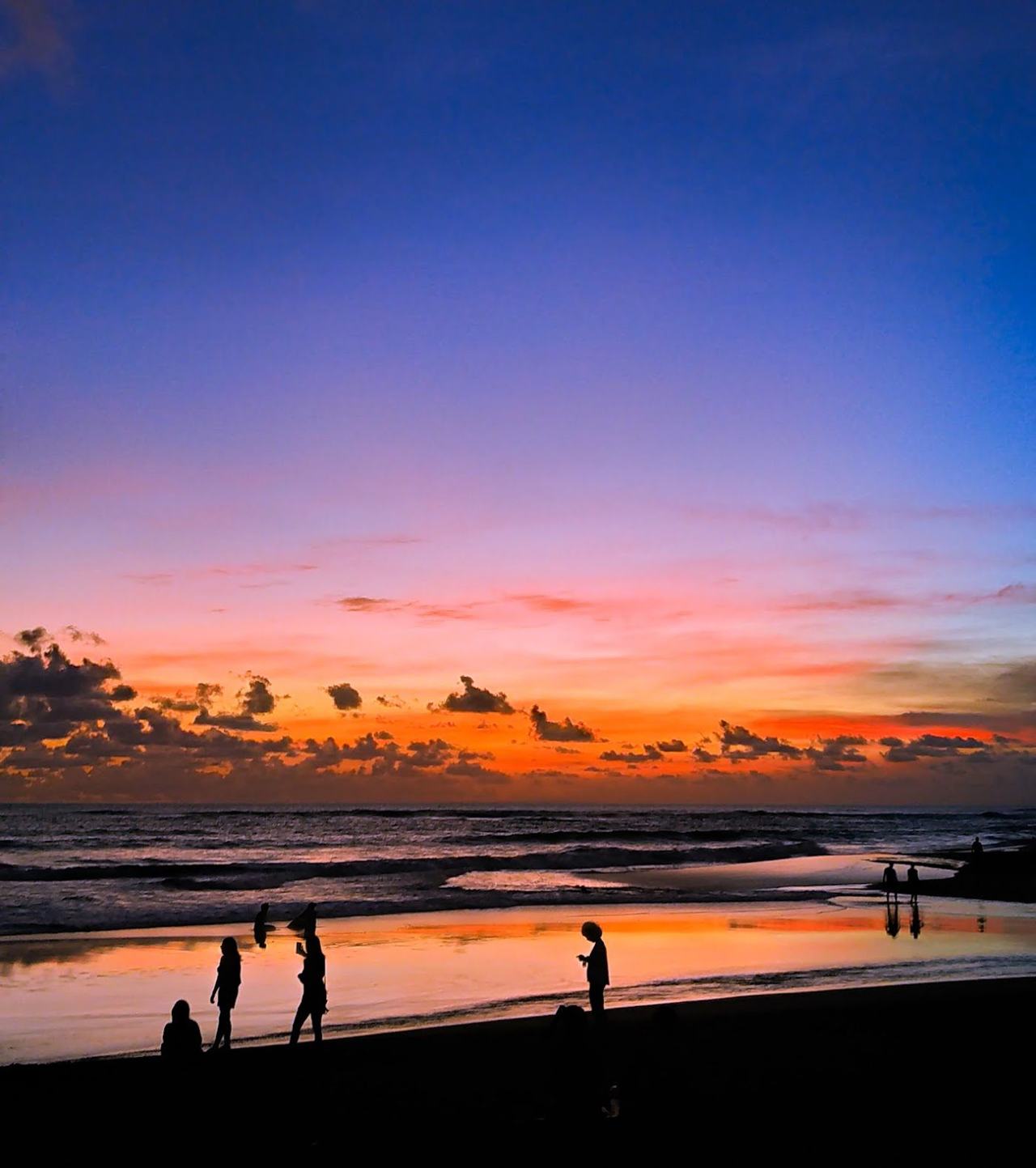Black volcanic sand and surf at Berawa Beach in Canggu Bali
