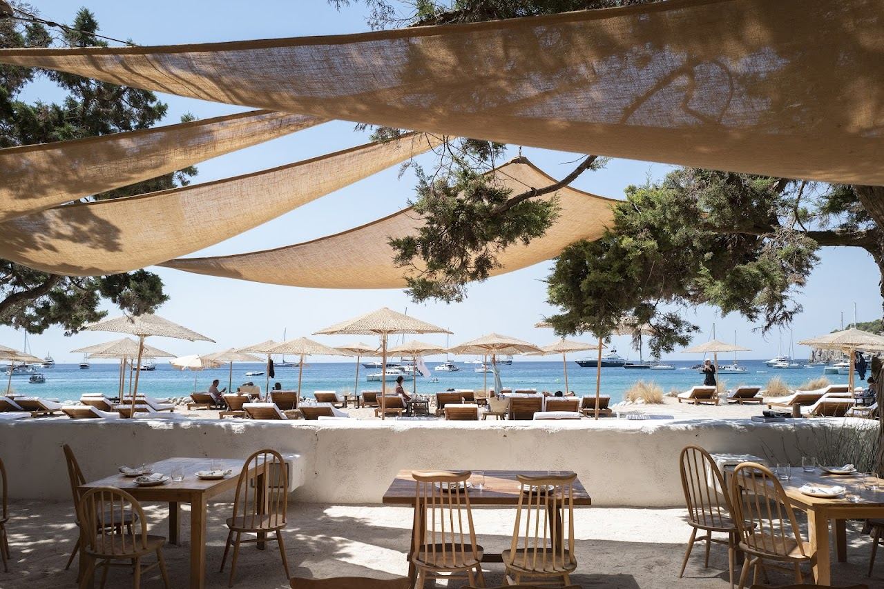 Daybeds beside the pebble shore at Cala Jondal on the south of Ibiza