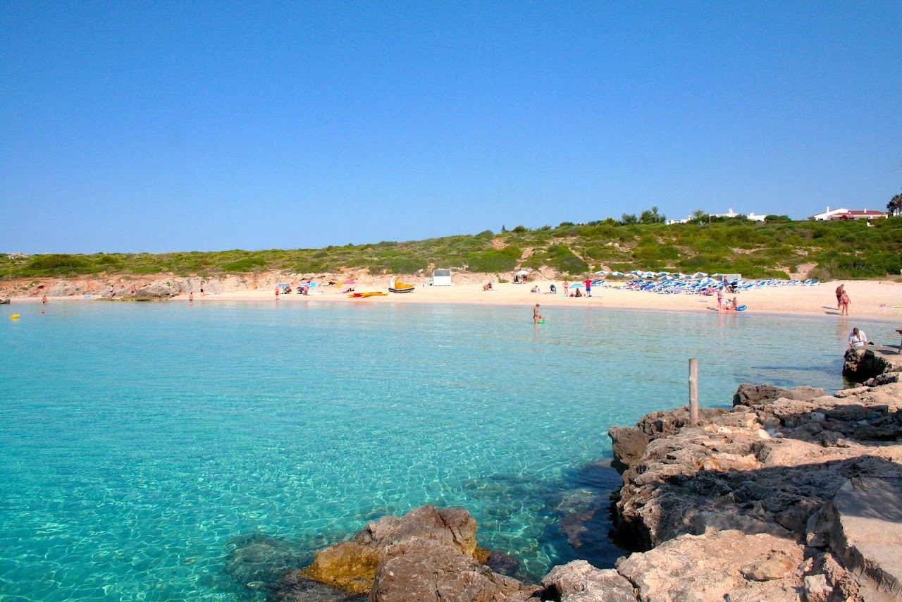 White sand and clear turquoise water at Binibeca cove on the southeast coast of Menorca