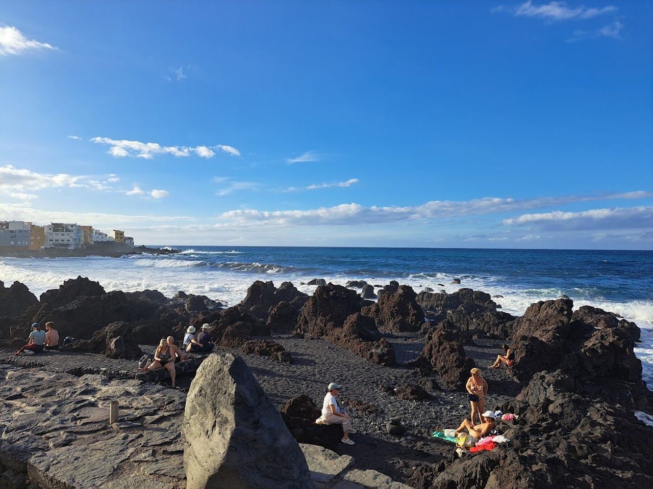 Designed black sand beach in Puerto de la Cruz with tropical gardens and a backdrop of Mount Teide.