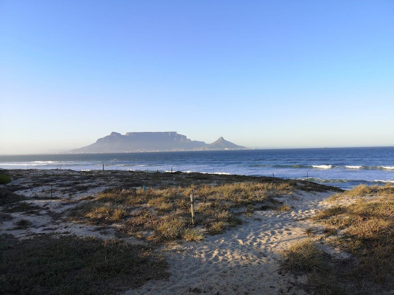 The long west coast beach of Bloubergstrand with Table Mountain rising across Table Bay in Cape Town
