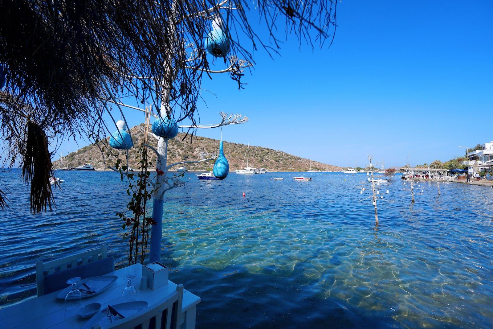 Clear shallow water and a rocky islet at Gumusluk on the western Bodrum peninsula