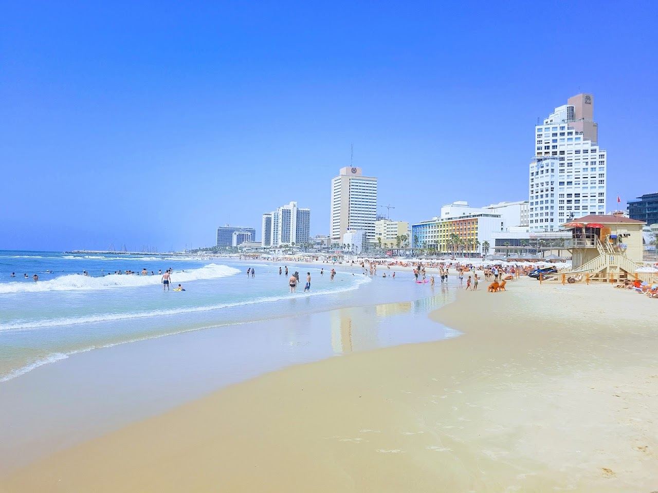 The soft golden sand and clear sea of Bograshov beach in central Tel Aviv