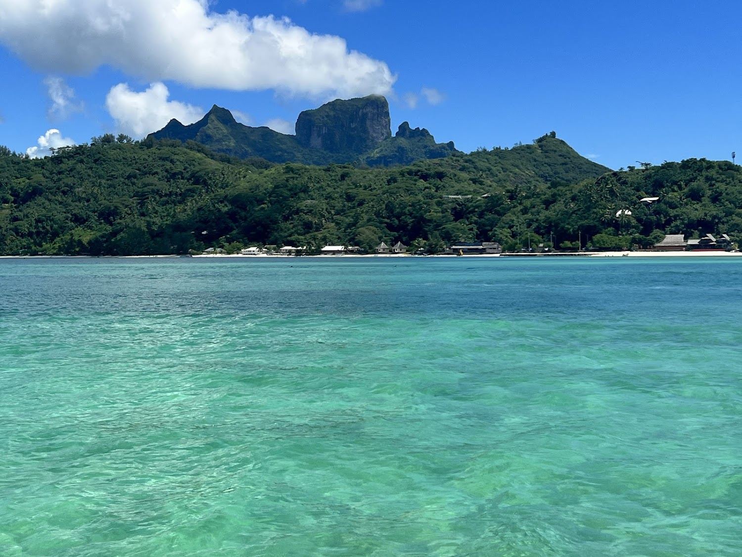 Still clear turquoise lagoon water under Mount Otemanu in Bora Bora